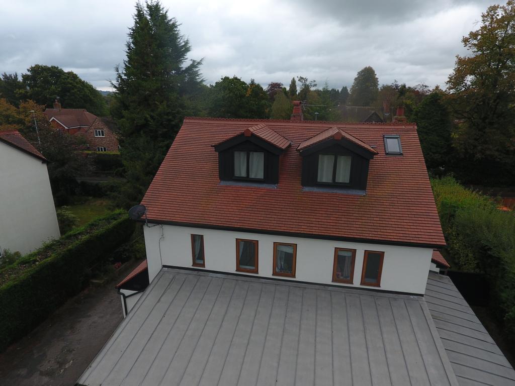 Picture of a new dormer roof, with red clay tiles by Roofers Manchester