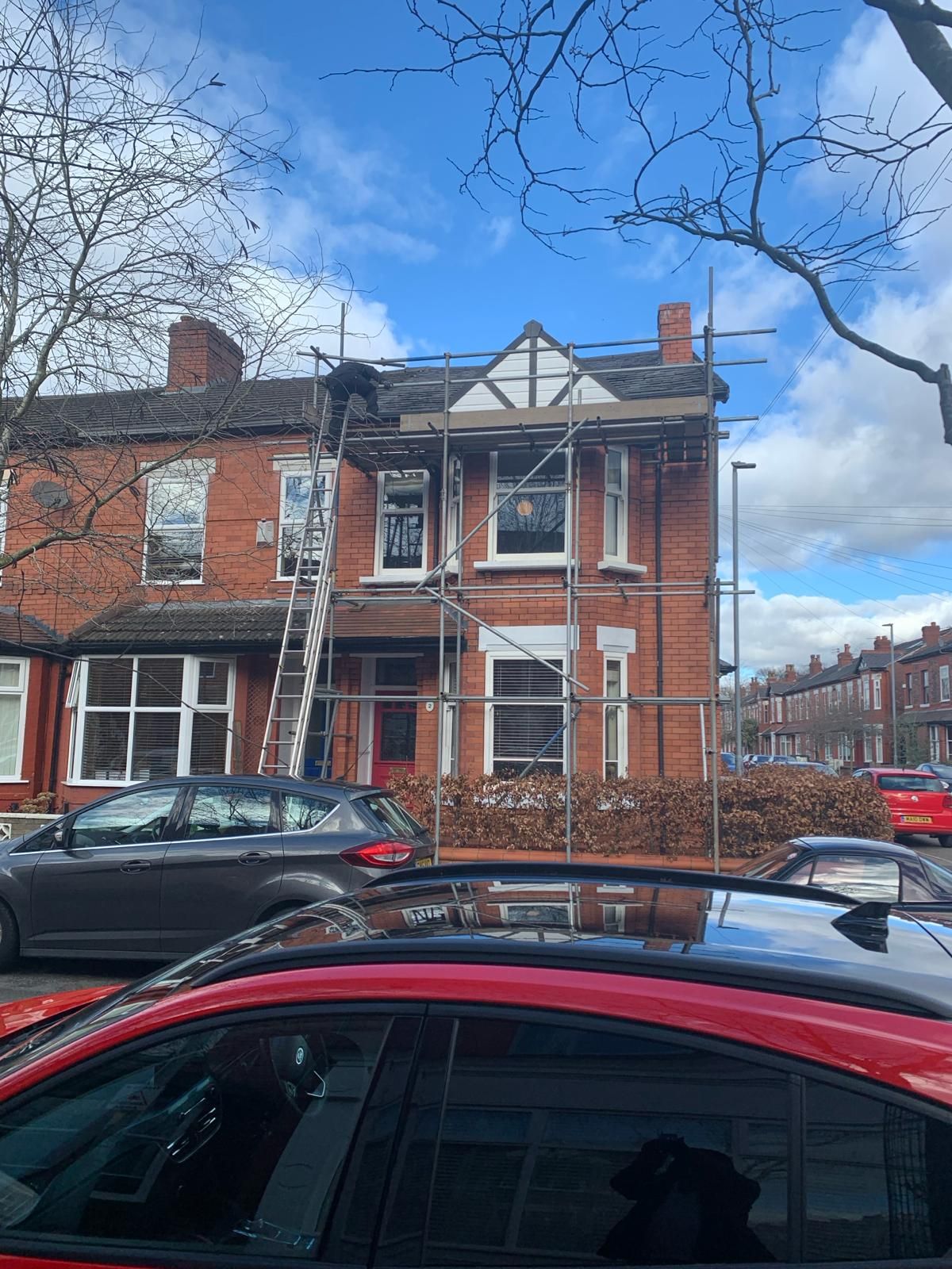 A picture of the Manchester Roofing team working on a roof of a house
