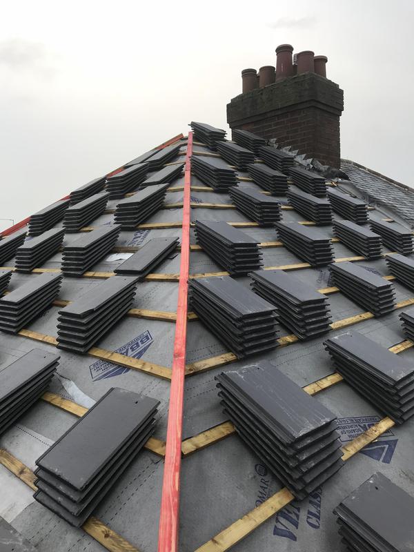 A picture of a hip roof replacement by Roofers Manchester