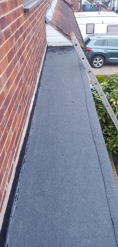 A picture of a narrow flat roof covered with felt by Roofers Manchester