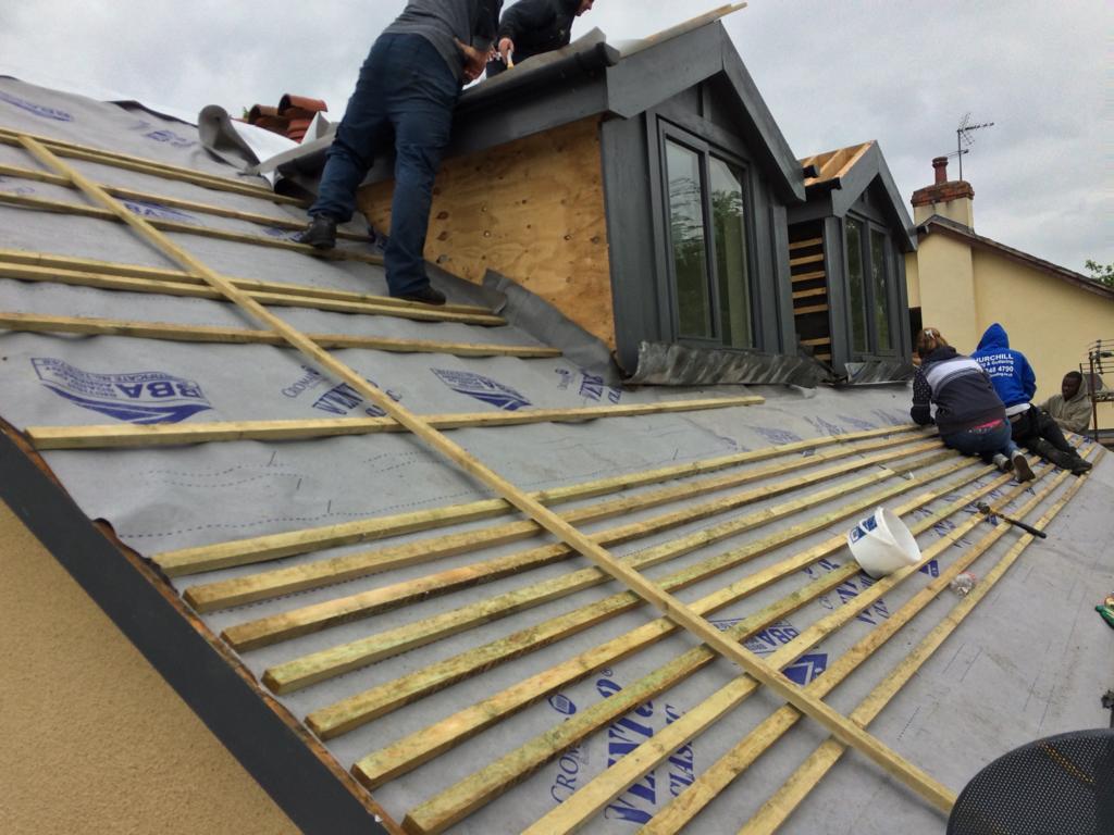 A picture of roofers Manchester working on a dormer roof