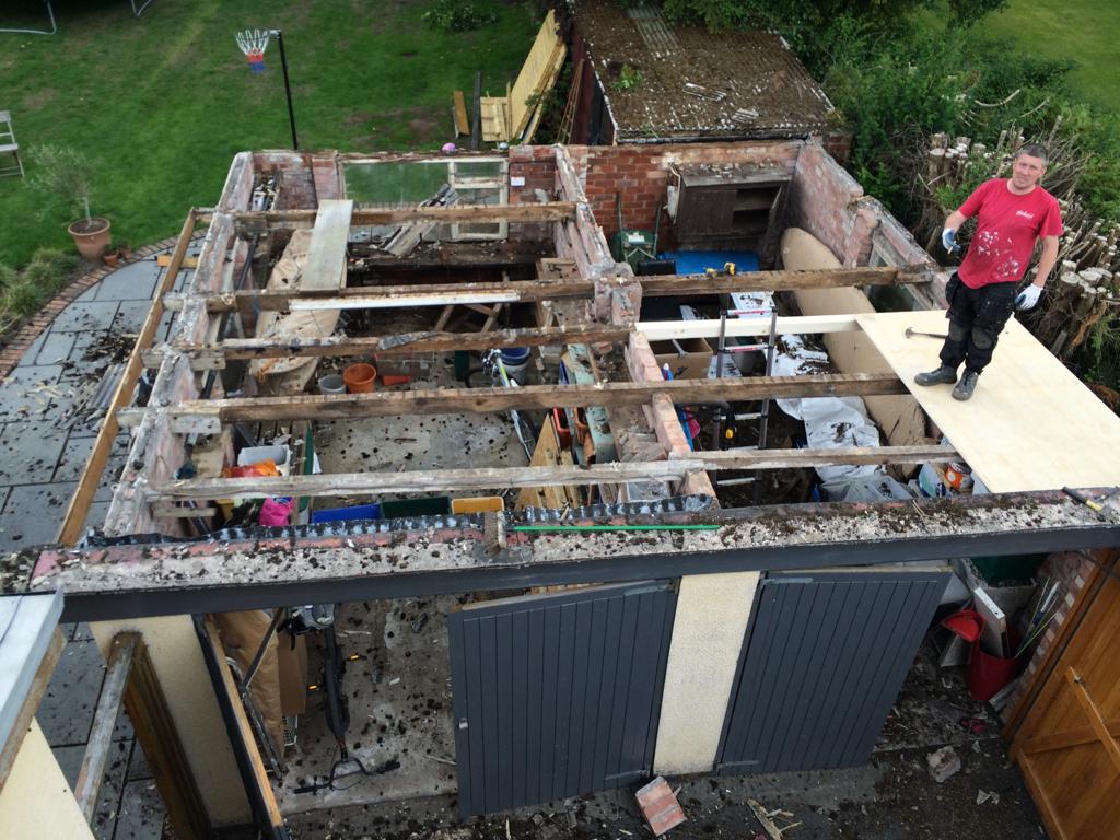 A picture of a flat outbuilding roof with the roof under construction by Roofers Manchester