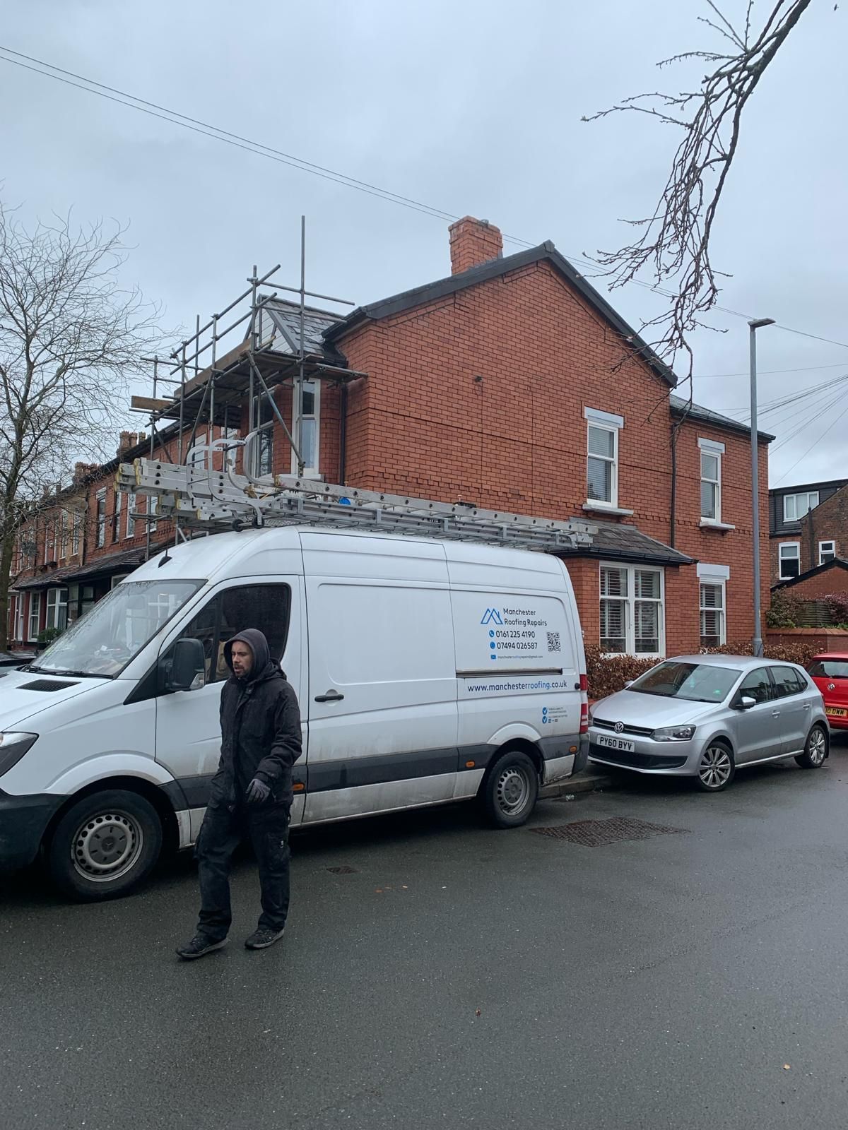 A picture of a gable roof with the Manchester roofing repairs team van outside