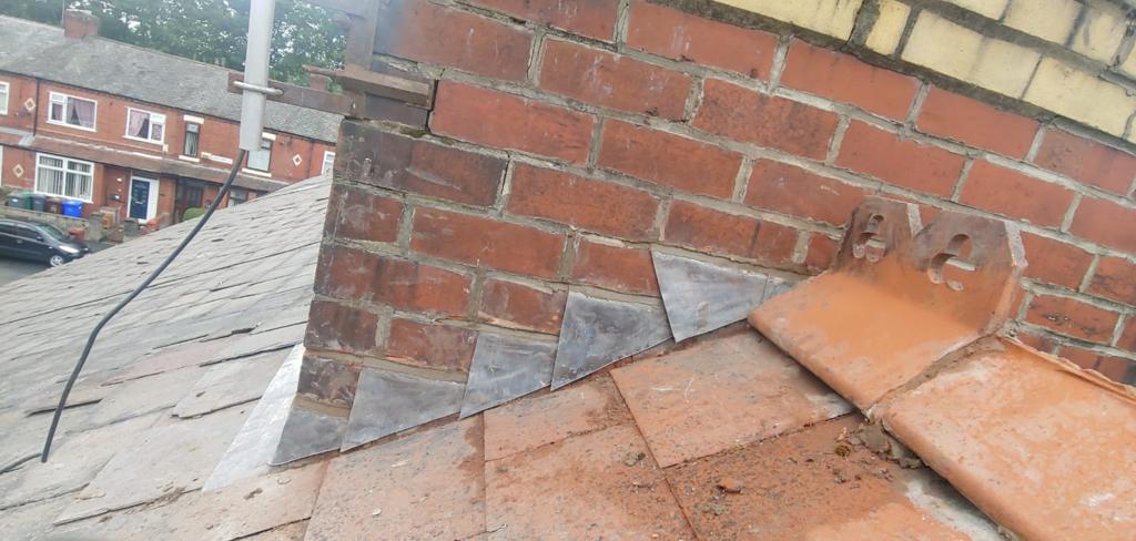 A picture of chimney flashing and ridge tile repair by roofers Manchester