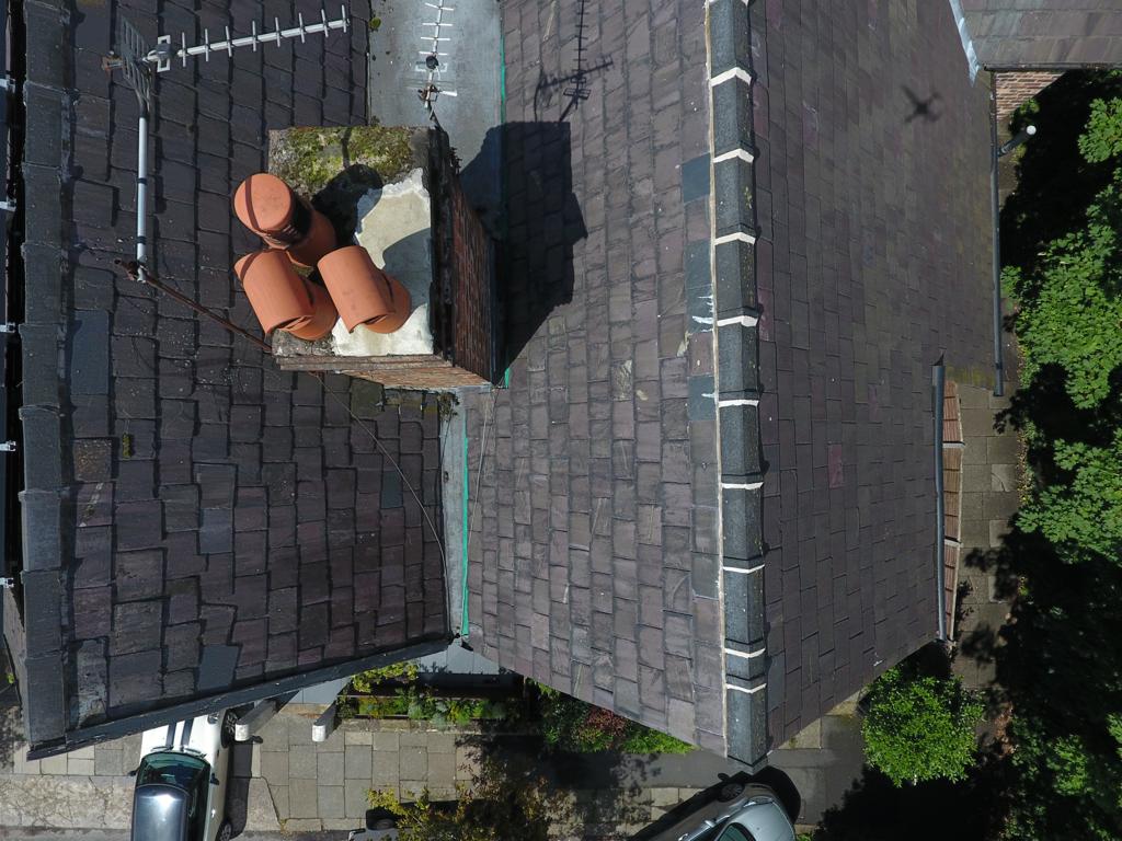 Aerial view of a chimney stack that has been repaired by Roofers Manchester