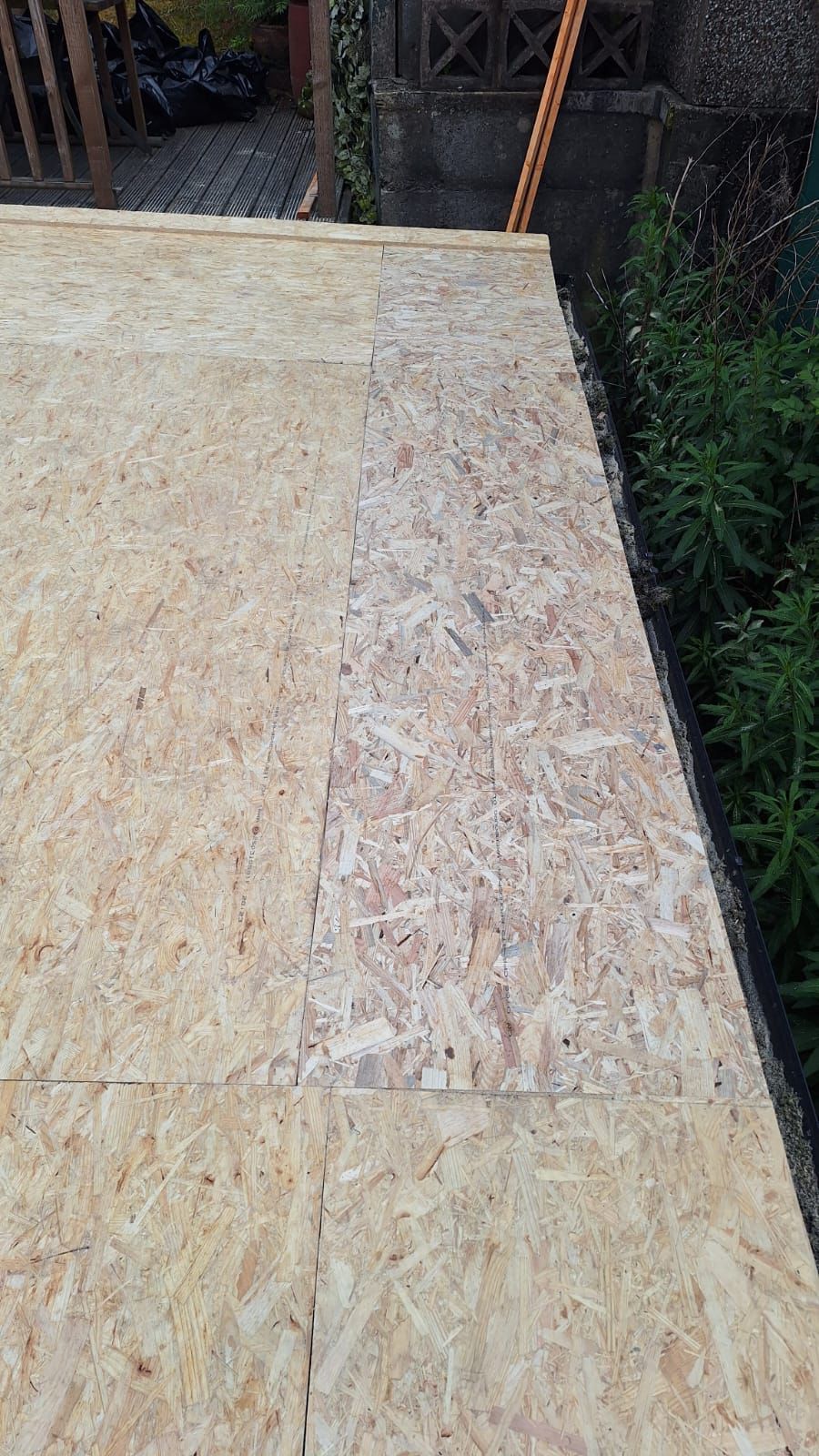 A close up of a piece of plywood on a roof.