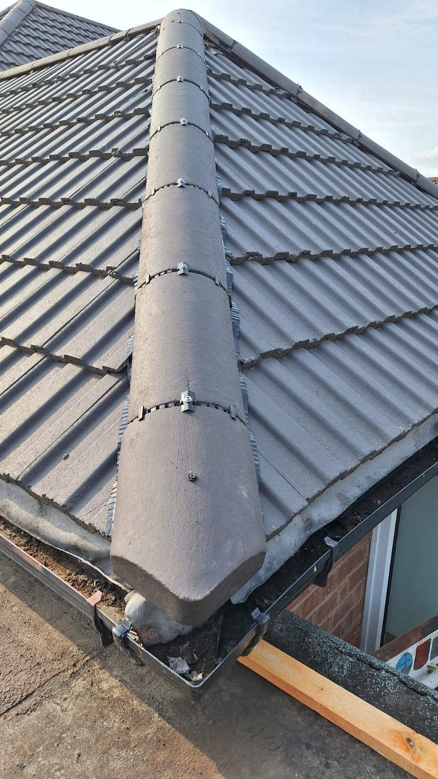 A close up of a roof with a gutter on it.
