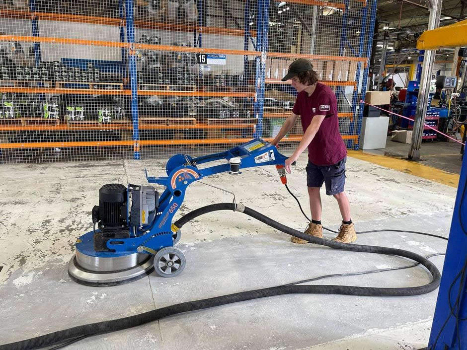 Worker Using Floor Polisher — Epoxy Floor Coating in Mackay, QLD