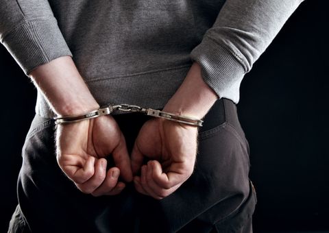Felony Defense Attorney — Outlaw's Hands Locked in Handcuffs in San Antonio, TX
