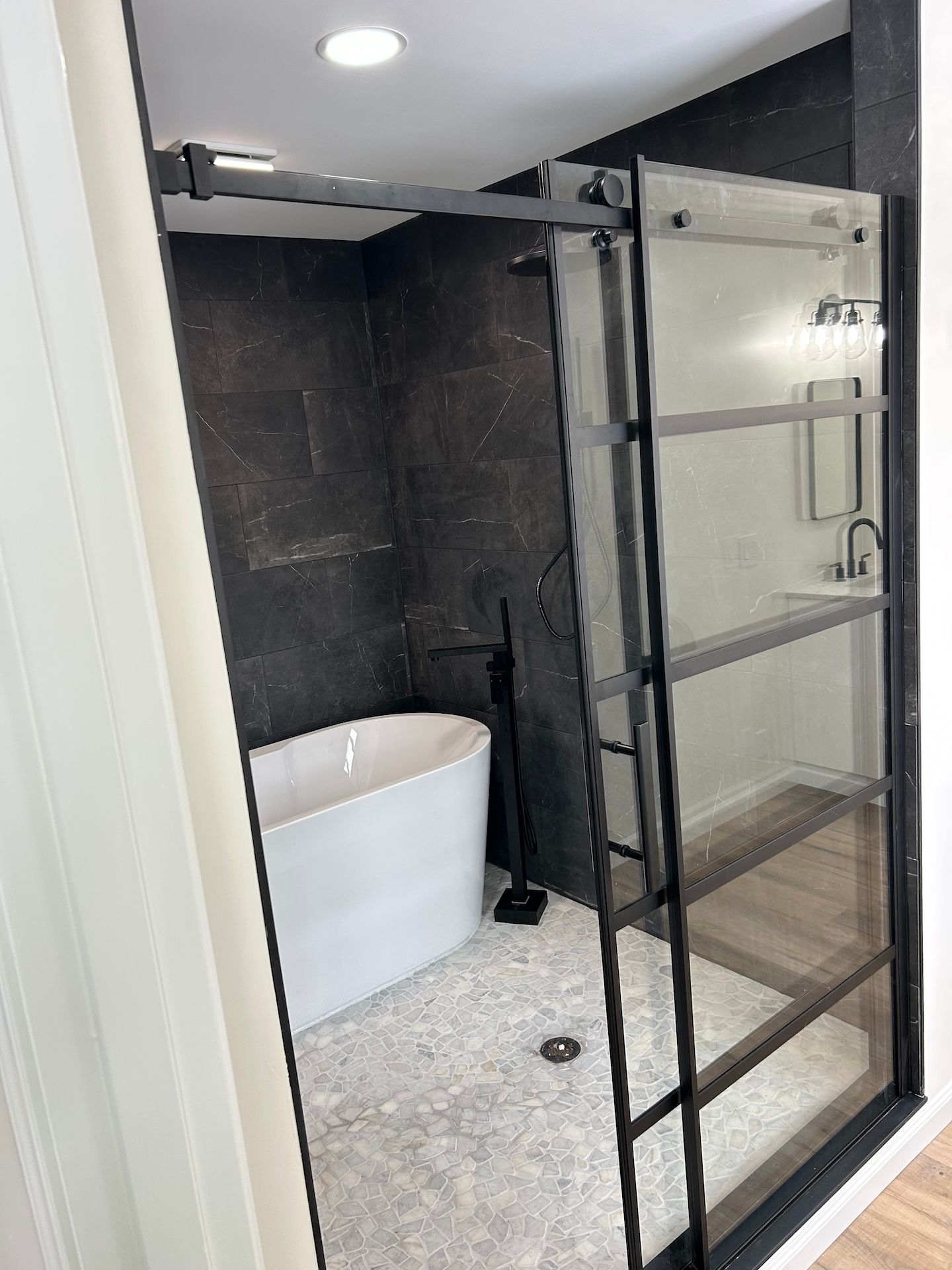 A bathroom with a bathtub and a shower stall.