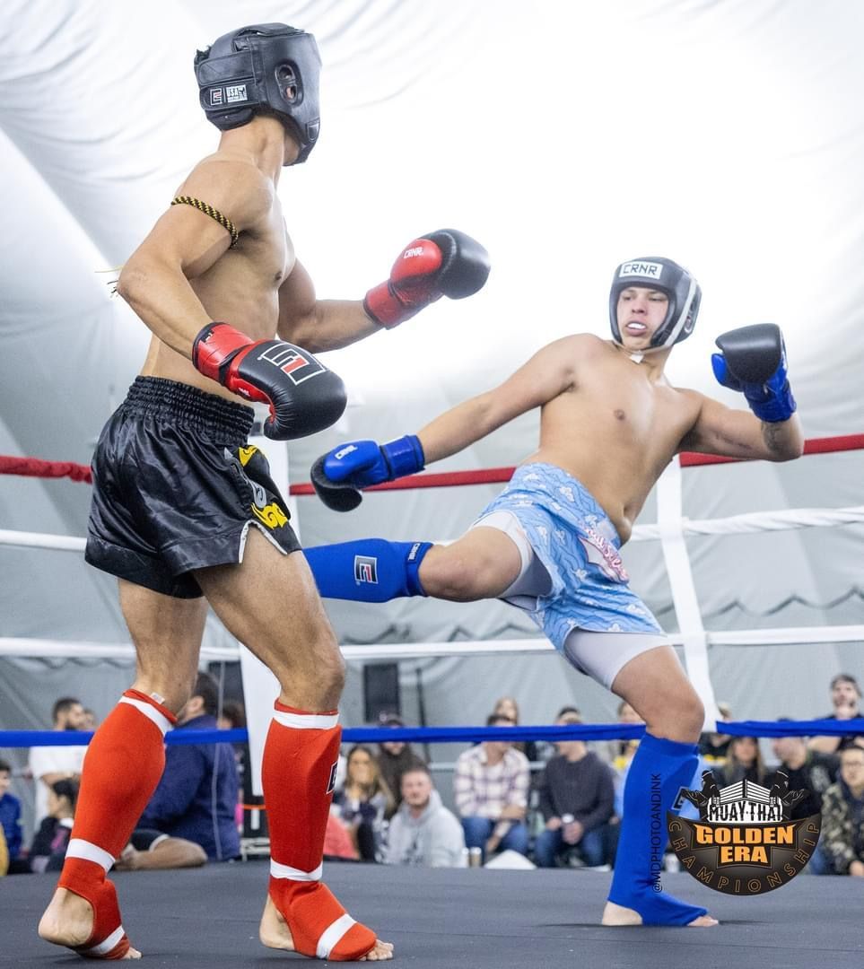 Two men are boxing in a ring and one of them has the word gulben on his shorts