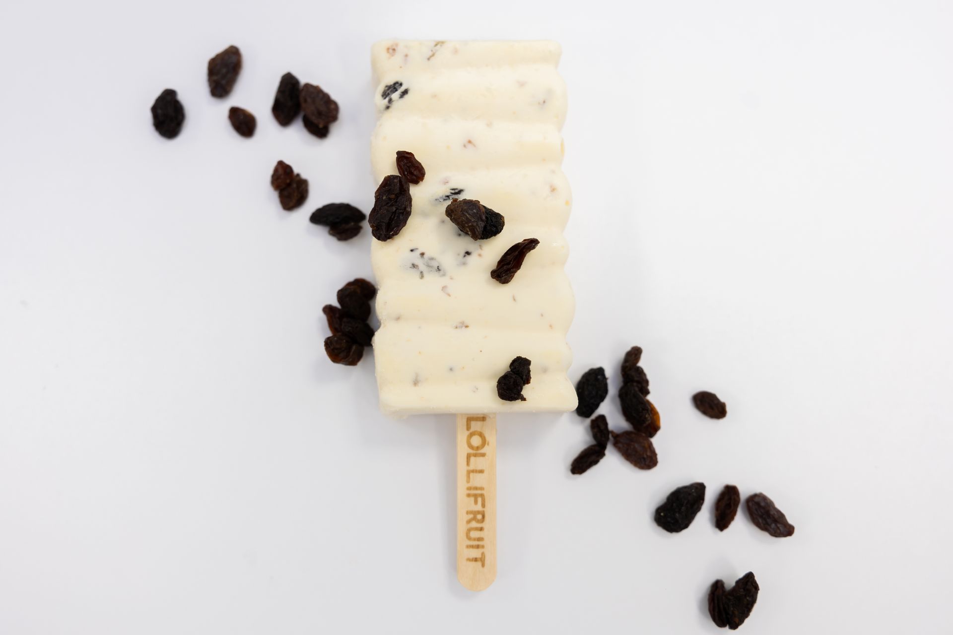 A lollifruit ice cream bar with raisins on it