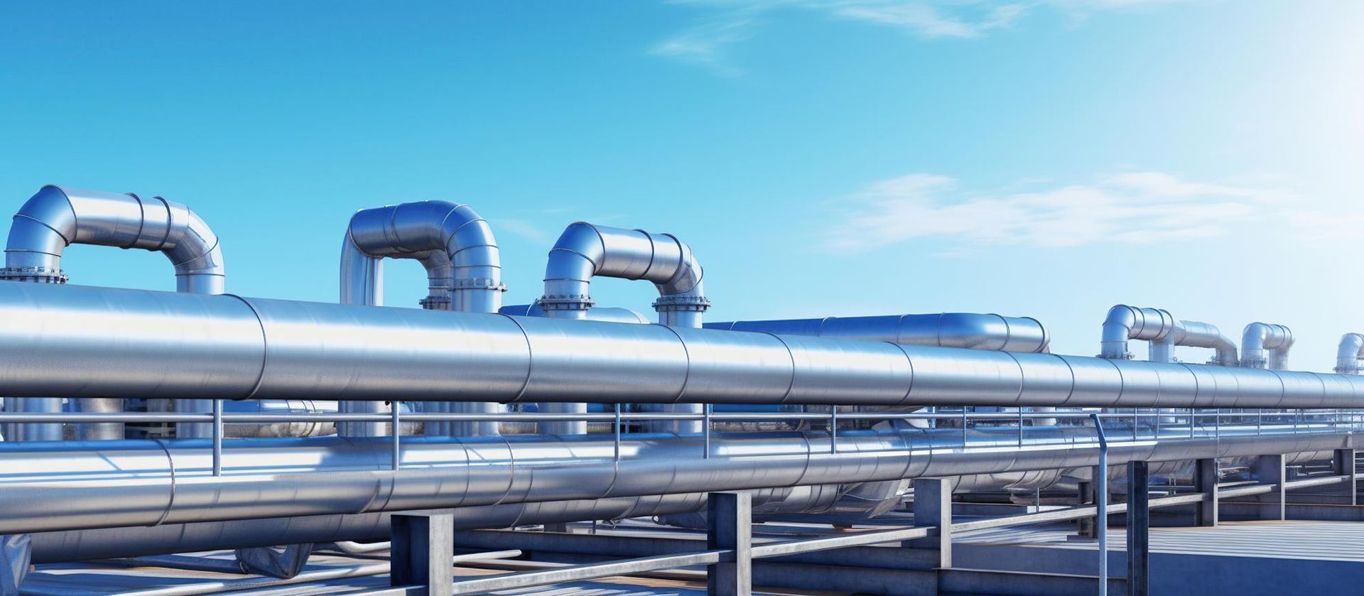 Pipes against a blue sky, possibly an industrial setting.