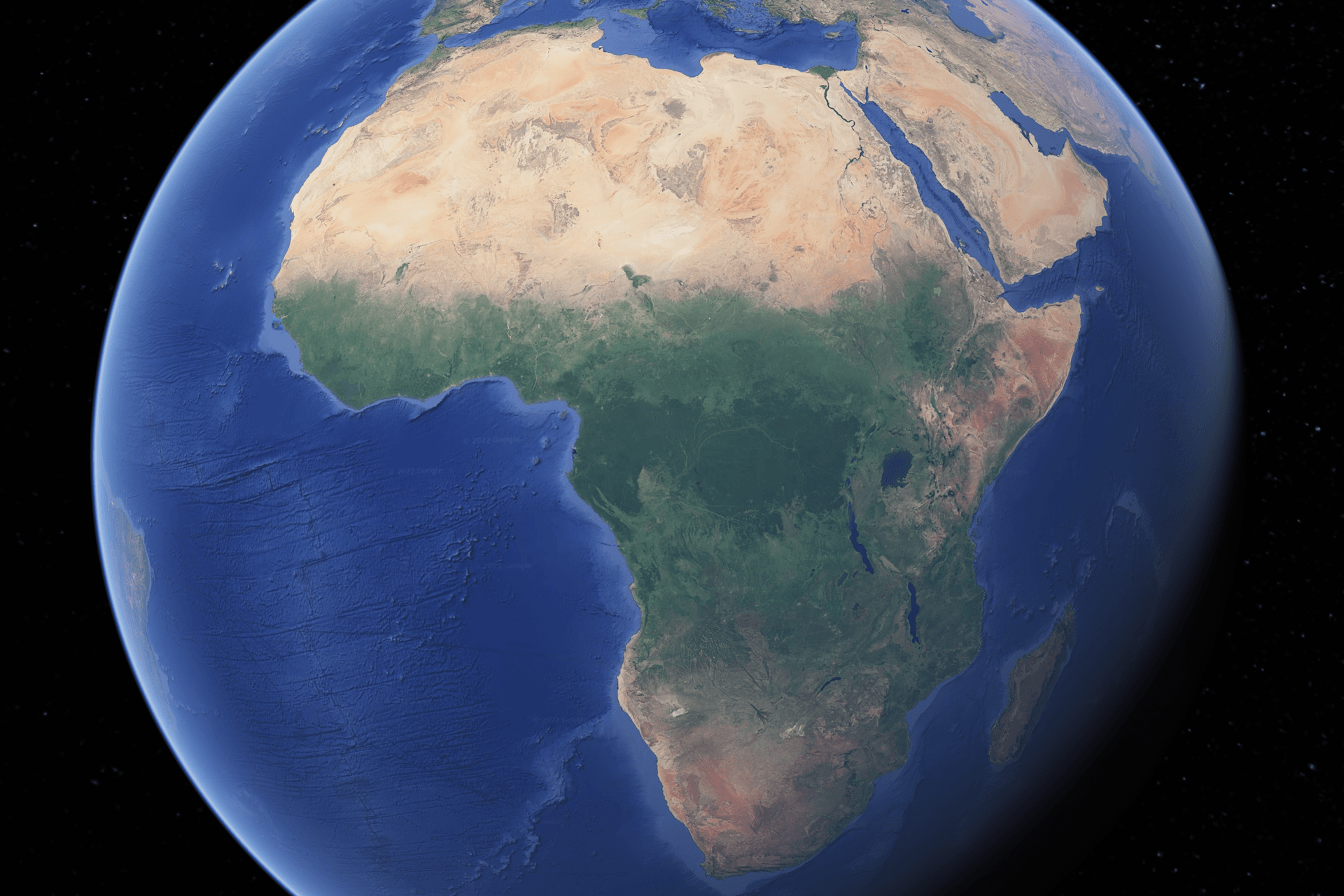 Earth from space, centered on Africa; landmass shows varying shades of brown and green, surrounded by blue ocean.