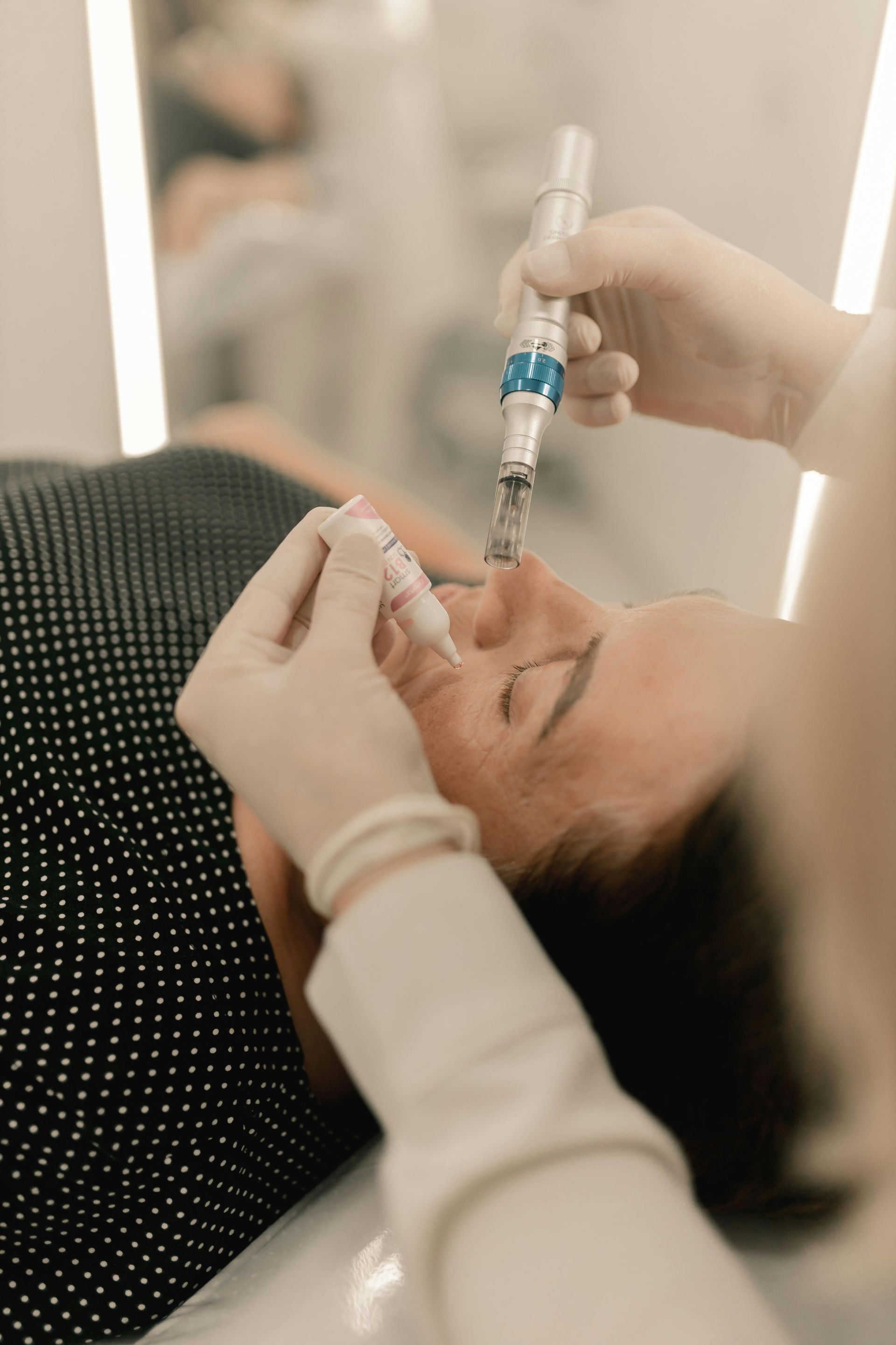 A woman is getting a facial treatment at a beauty salon.