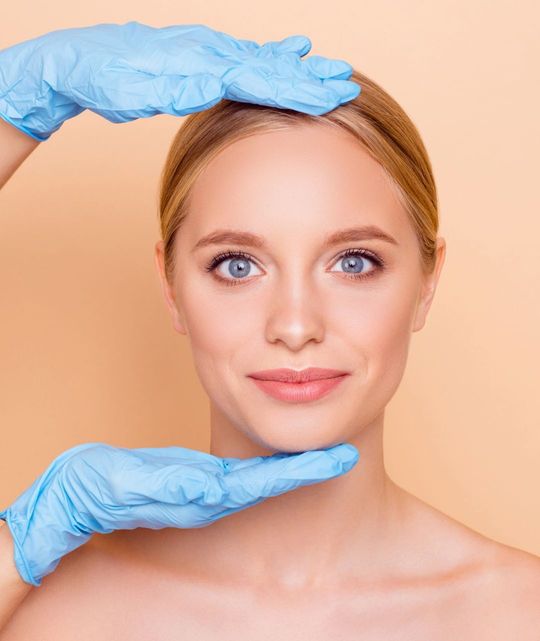 A woman is getting a facial treatment at a beauty salon.