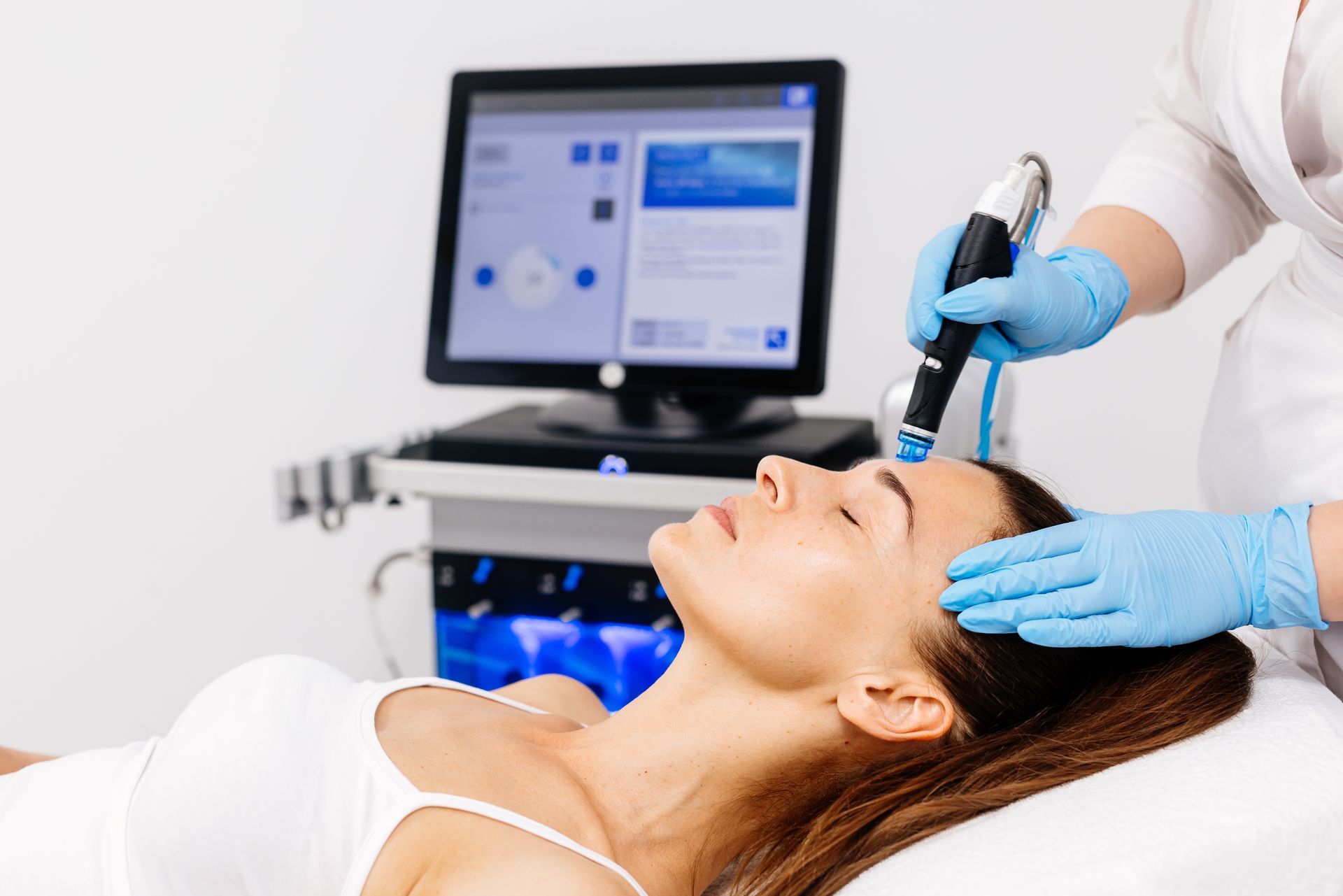 A woman is getting a facial treatment in a beauty salon.