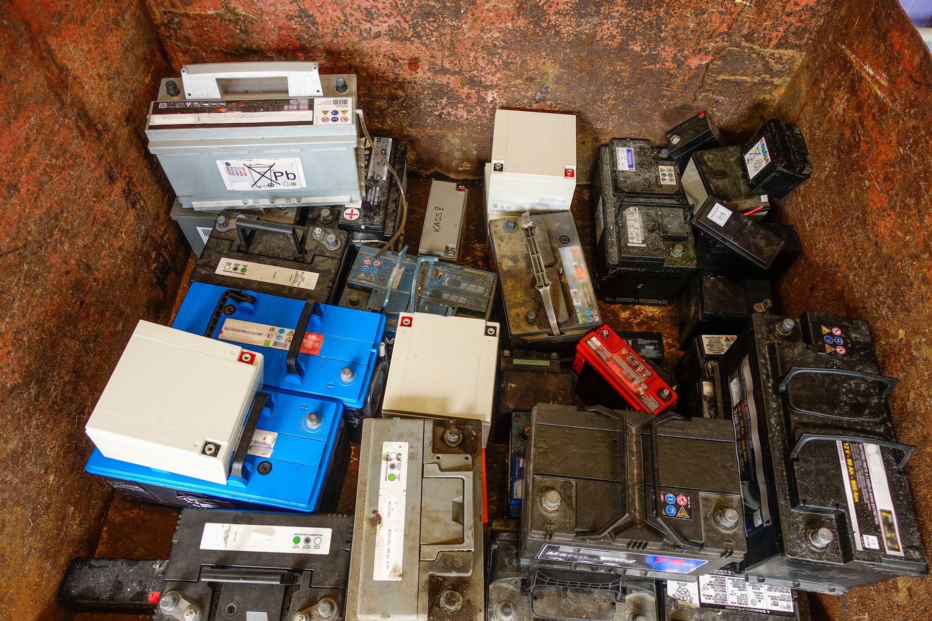 A bunch of batteries are sitting in a bin