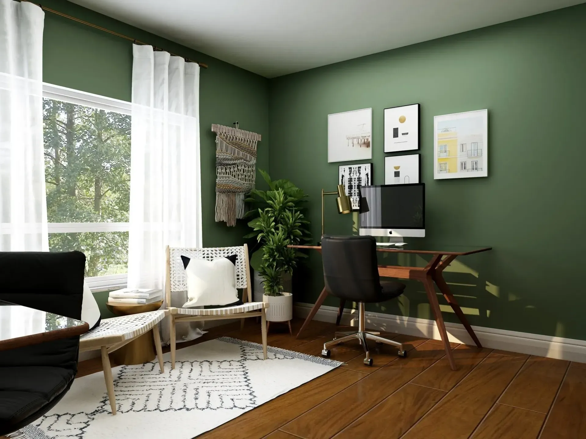 A living room with green walls and a desk with a computer on it.