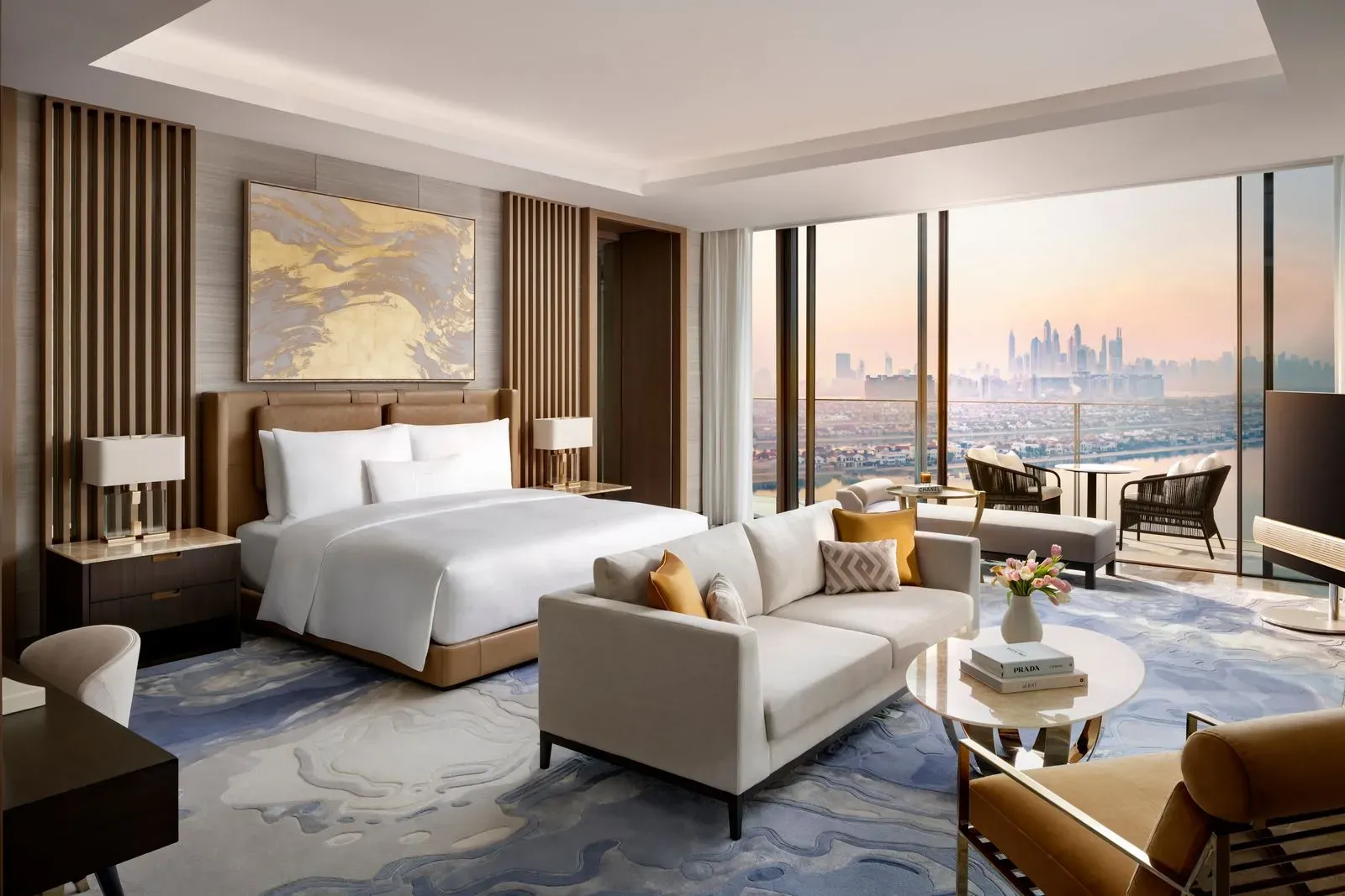 An artist 's impression of a hotel room with a large bed , couch , table and chairs.
