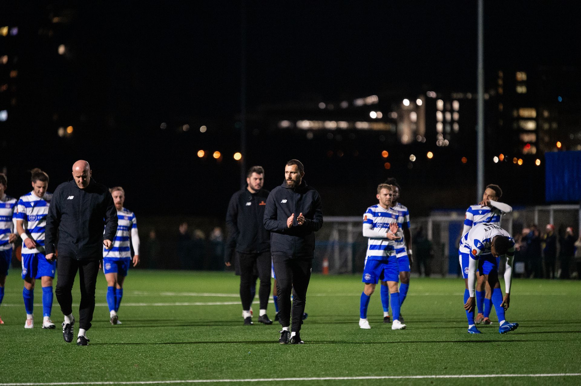 Ross Jenkins applauds the City supporters with players after a match.