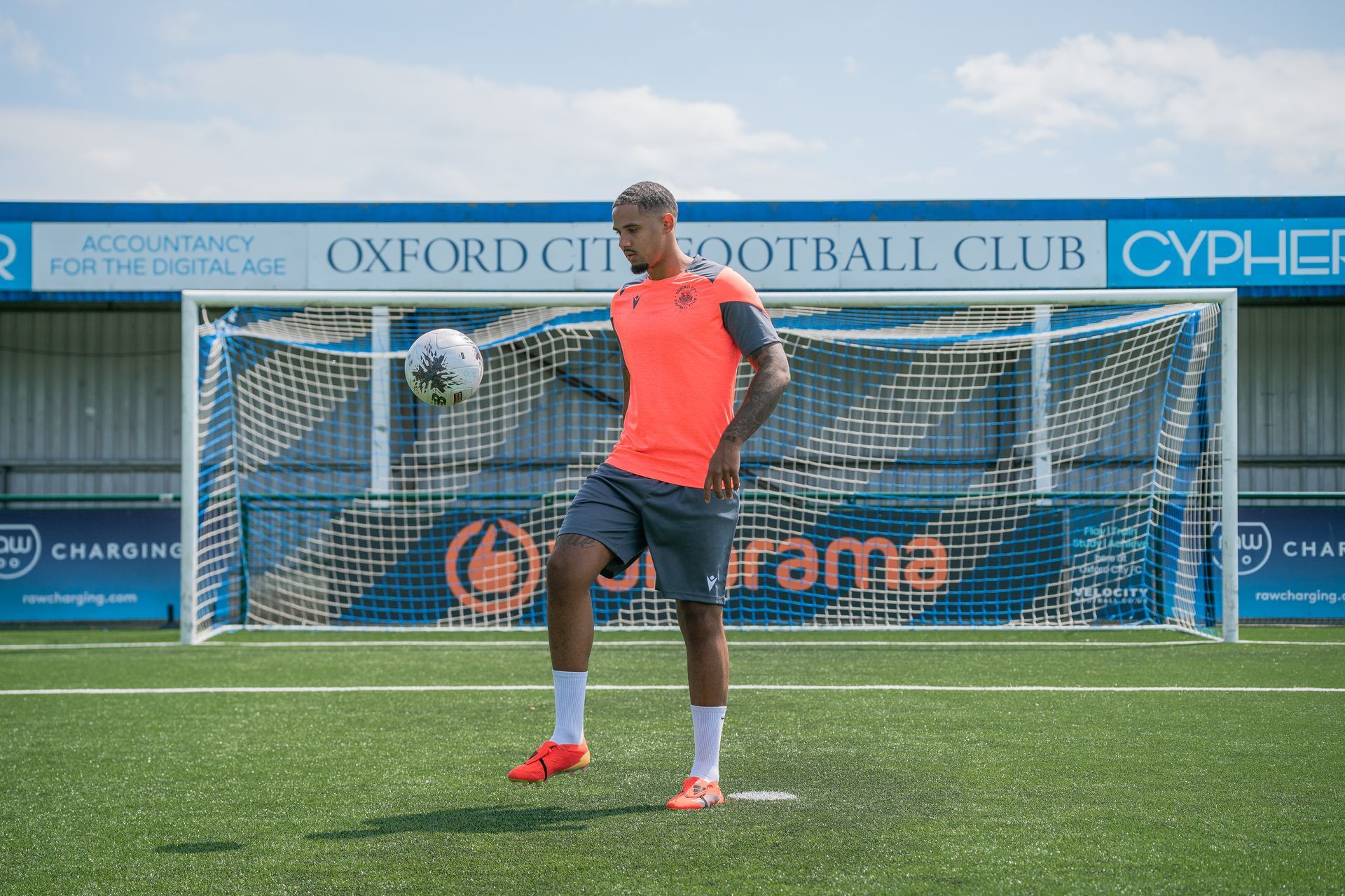 Cole Kpekawa doing kick-ups under Oxford City FC sign