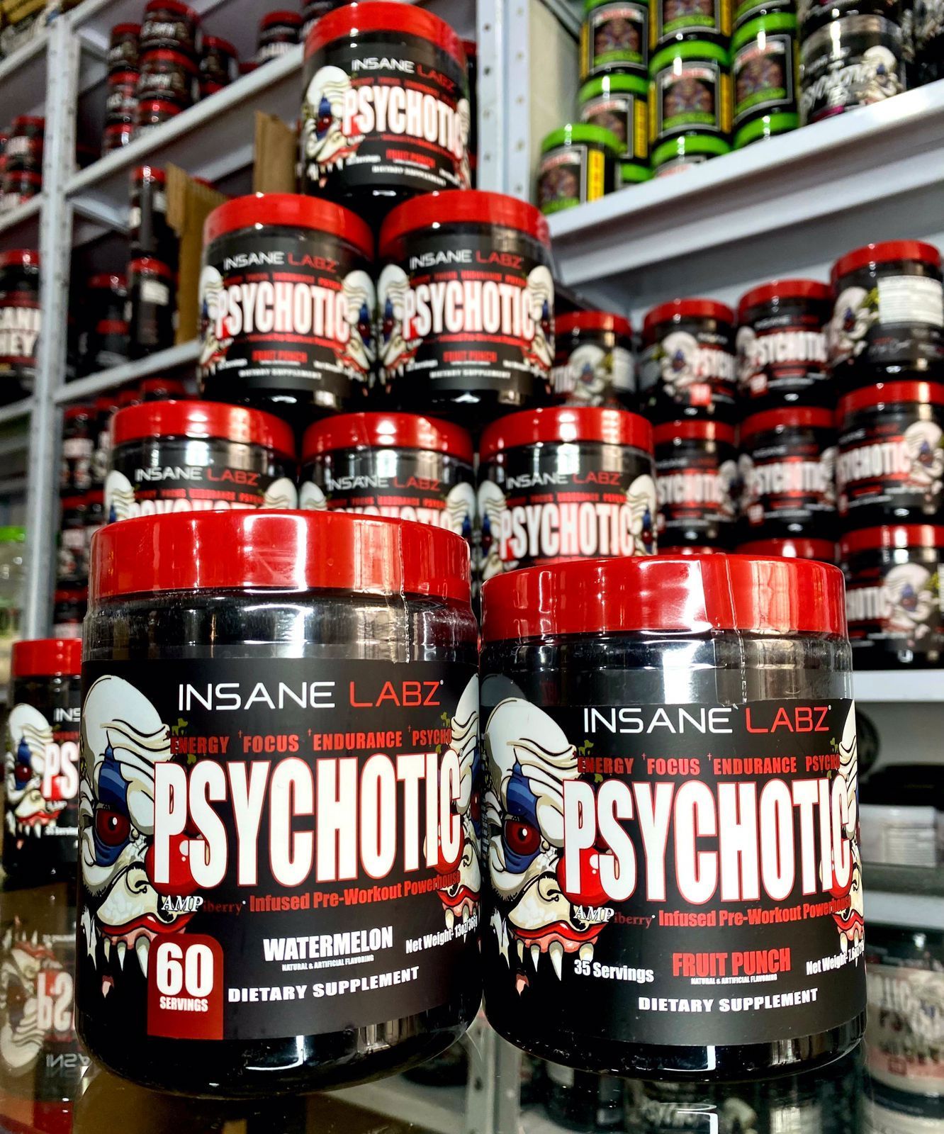 Frascos apilados de color negro y rojo del suplemento Insane Labz Psychotic en un estante de una tienda.