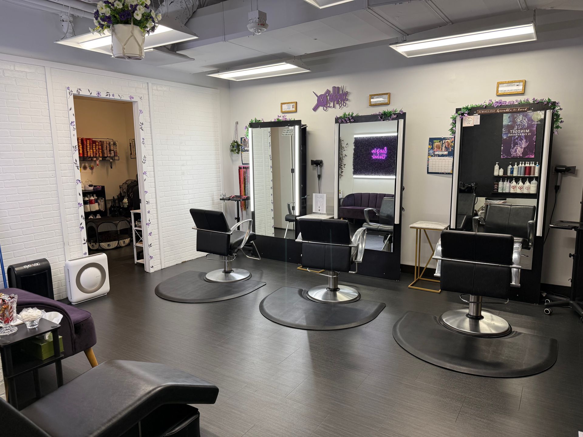 Maddy's Hair salon interior with styling stations, mirrors, and products.