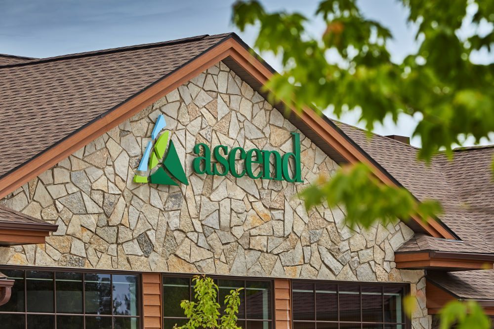 A large stone building with the word ascend on it