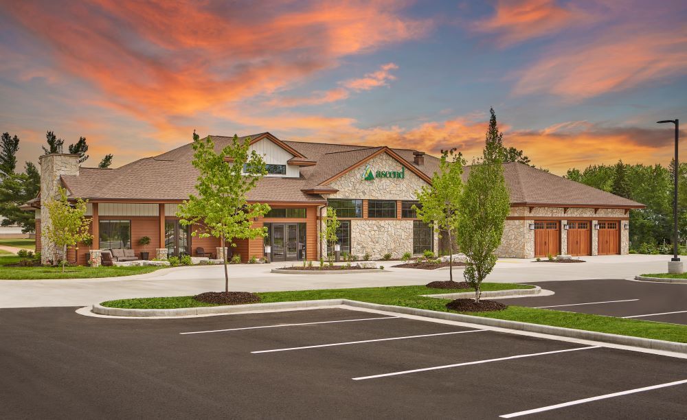 A large building with a parking lot in front of it.