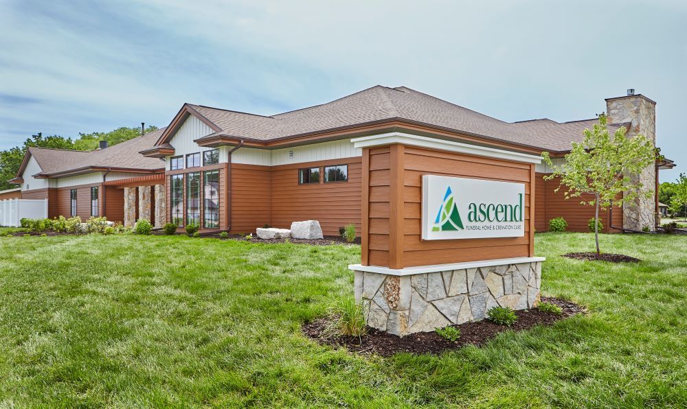 A large house with a sign in front of it.