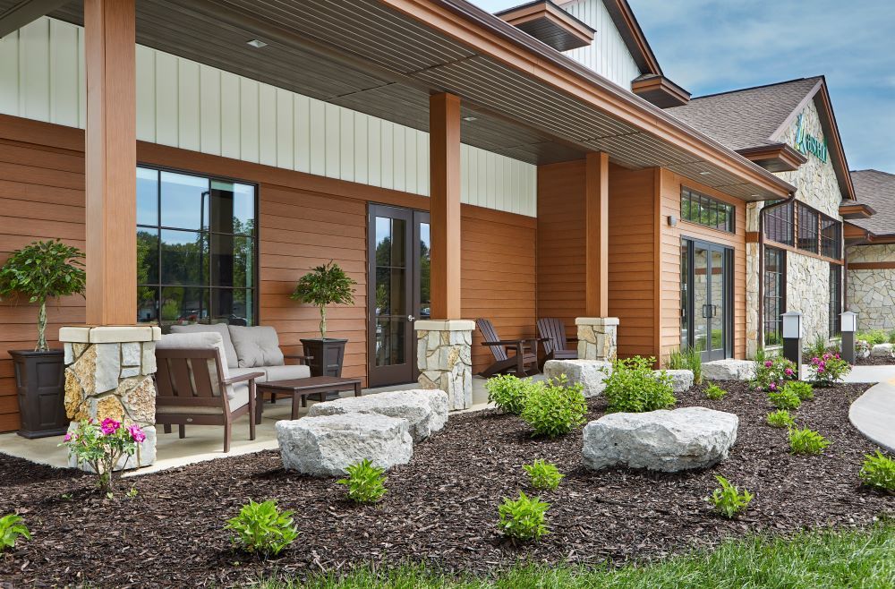 A large building with a patio area in front of it.