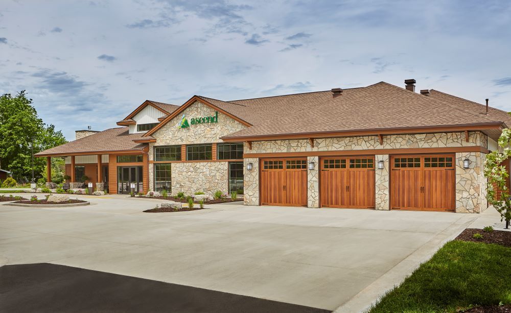 A large house with a lot of garage doors and a driveway.