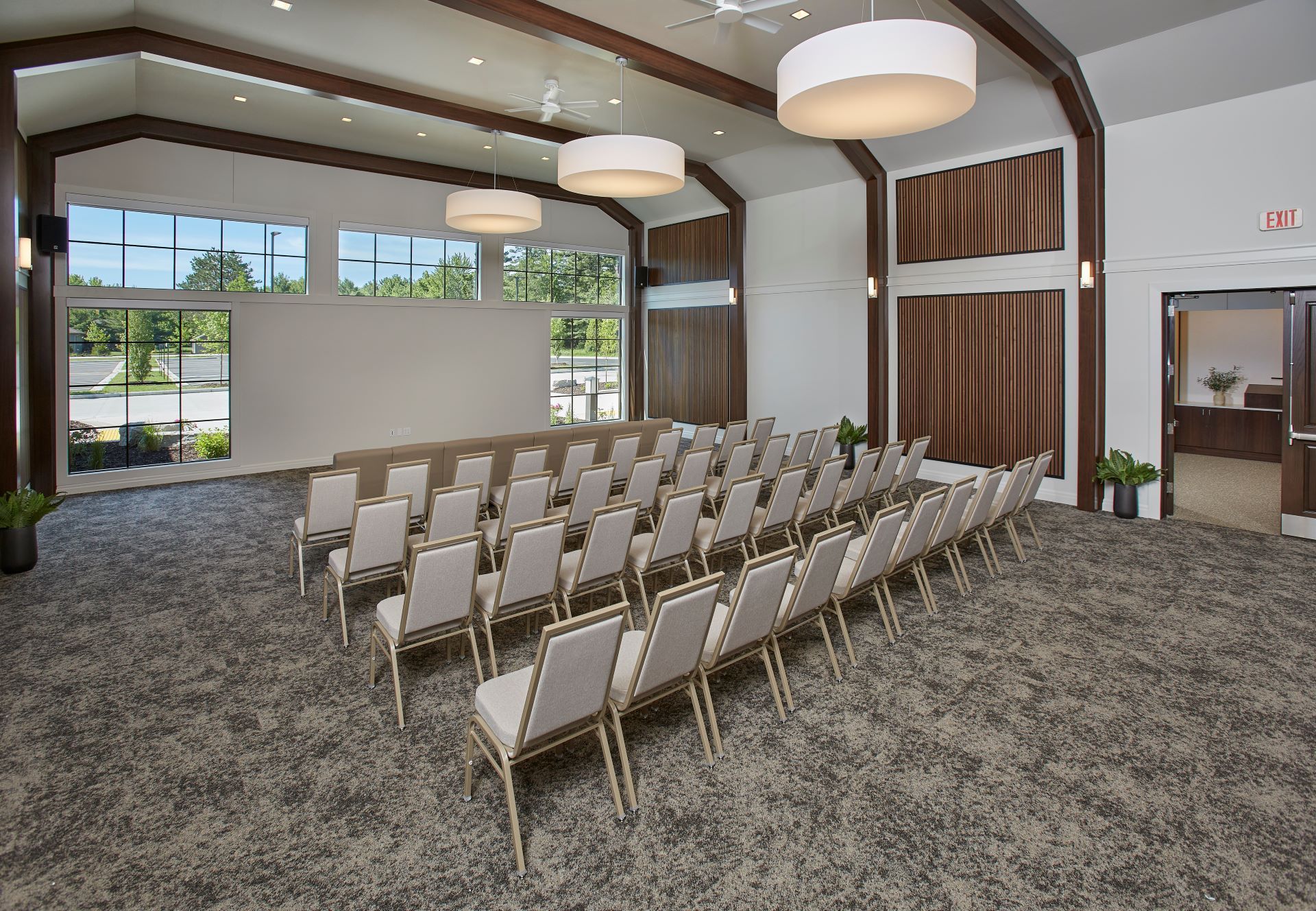 Rows of chairs are lined up in a large room