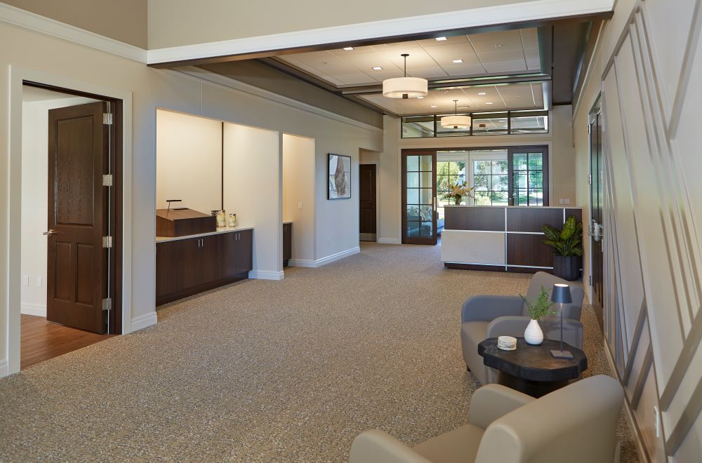 A large room with a couch and chairs in it