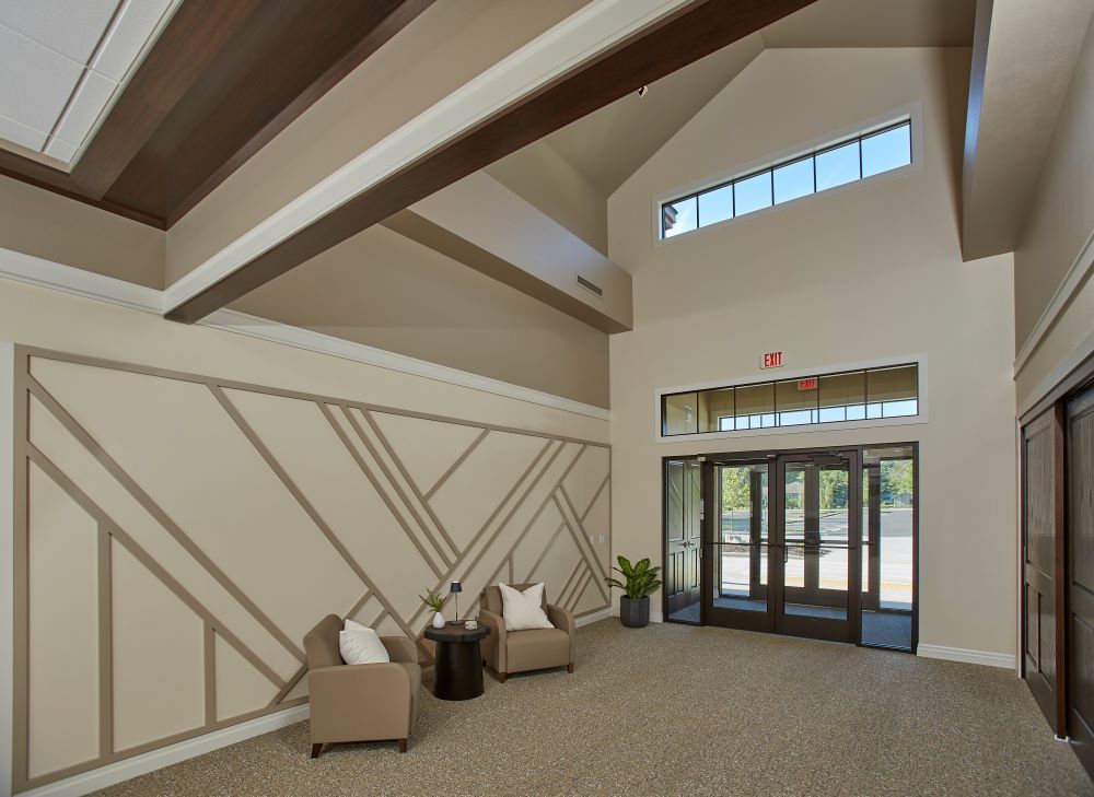 A large lobby with two chairs and a table