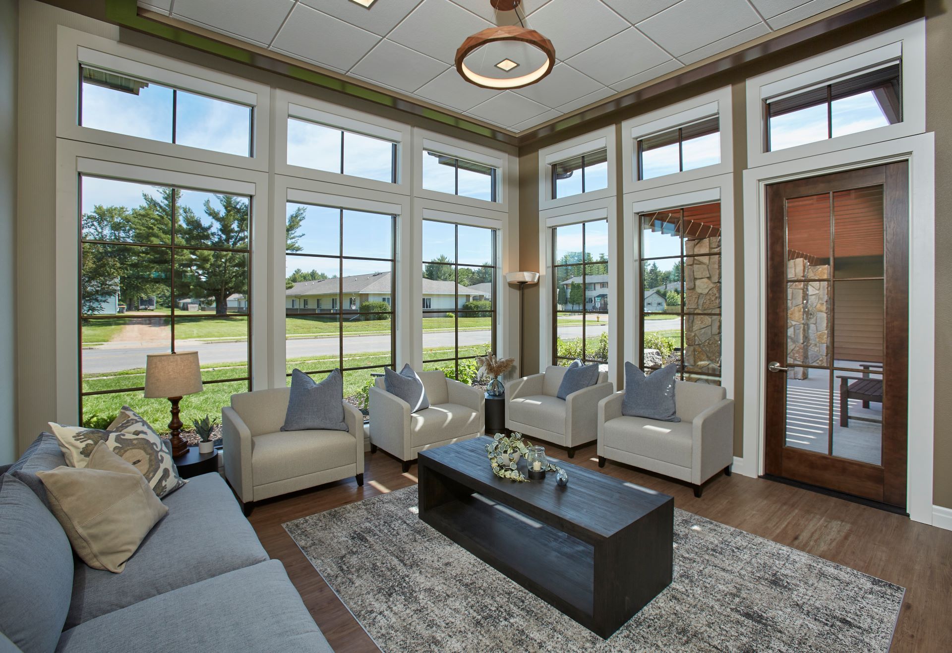 A living room with a couch , chairs and a coffee table
