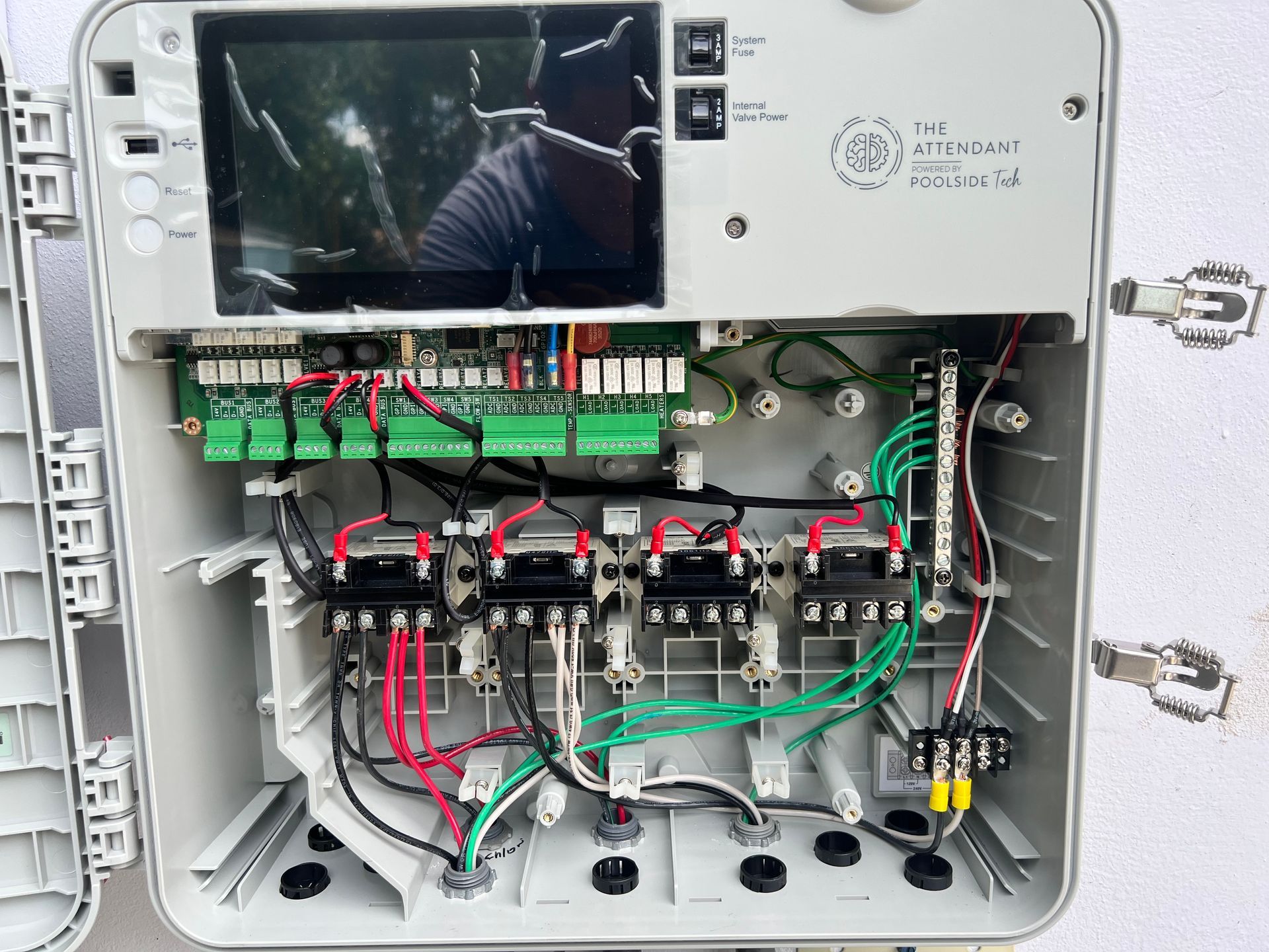 Open irrigation controller with wiring and circuit board visible, indoors.