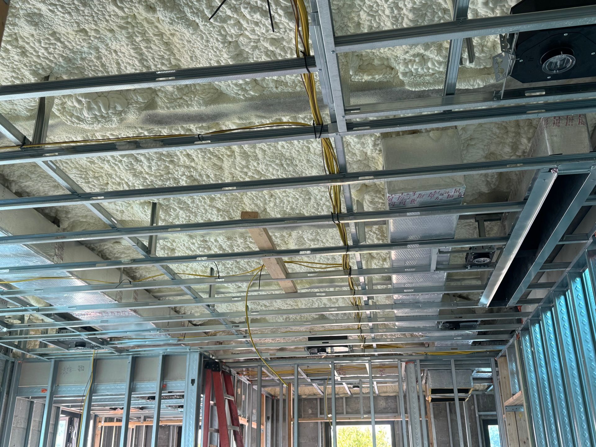 Ceiling framework with insulation and wiring during construction.