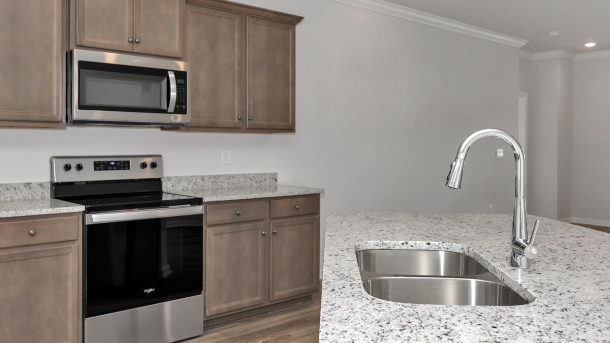 Kitchen with gray cabinets, stainless steel appliances, and granite countertops.