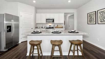 A kitchen with a large island in the middle of it.