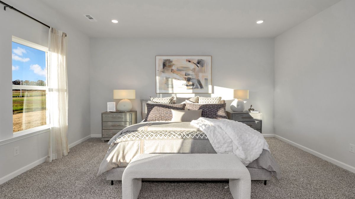 Bedroom with bed, nightstands, window, and artwork. Soft neutral colors and natural light.