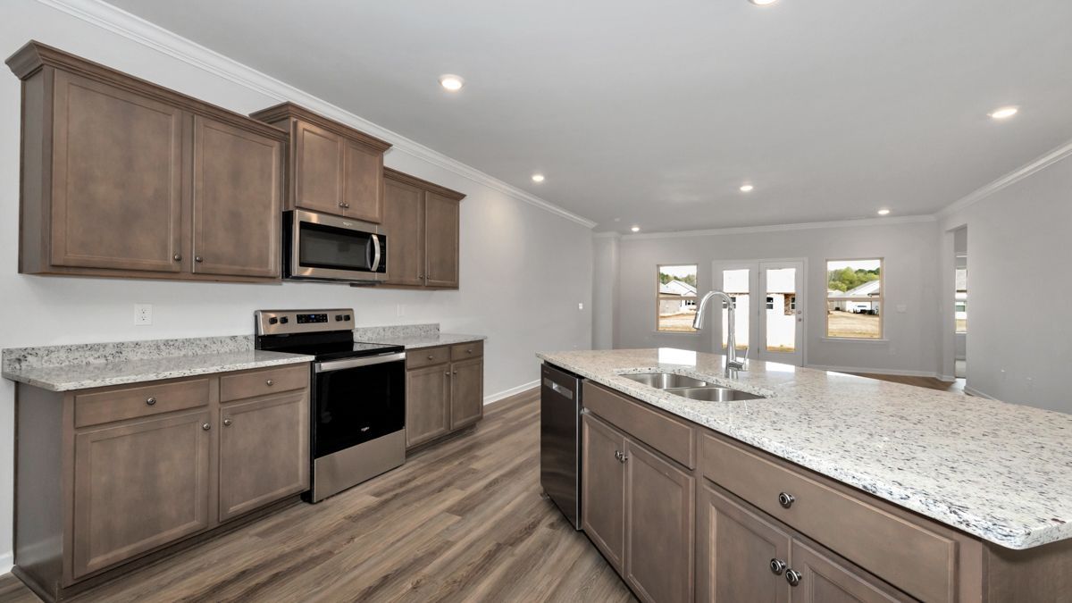 Kitchen with wood cabinets, granite countertops, and stainless steel appliances.