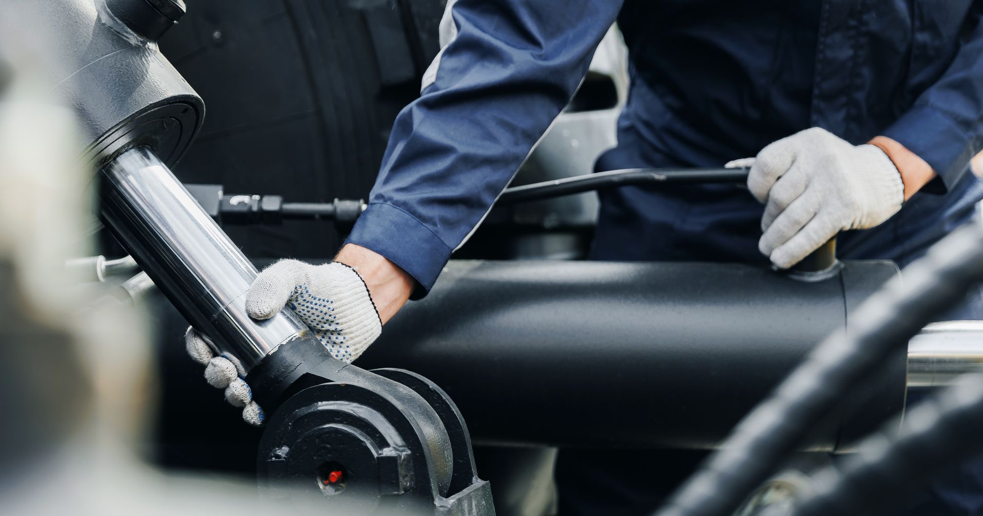Mechanic using a wrench to repair a car wheel in a garage