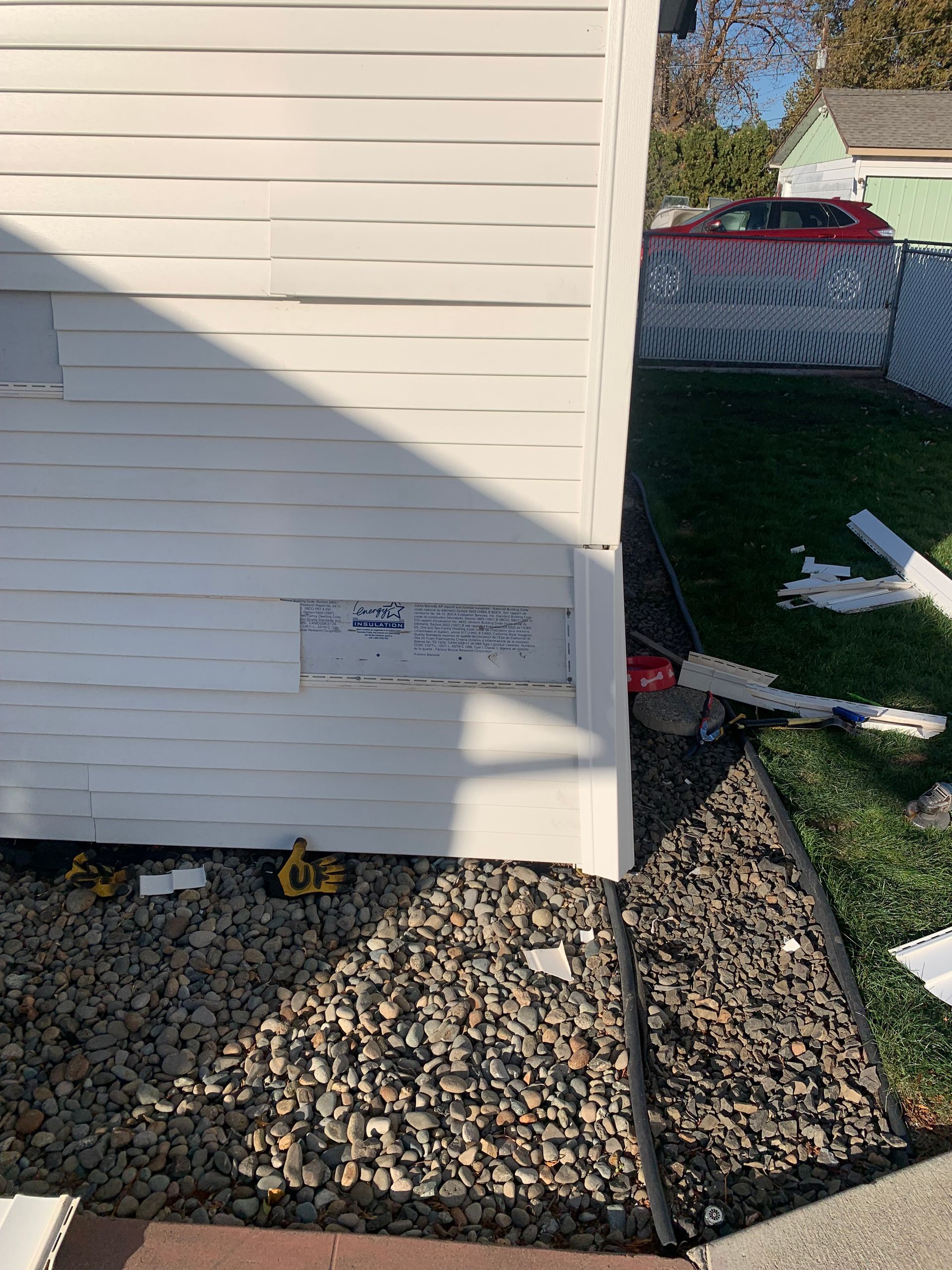 A photo of a vinyl siding repair in progress. 
