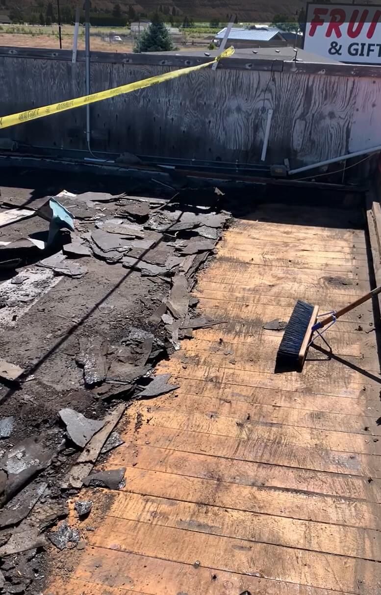 Exposed wooden substructure on the Naches Fruit Stand roof after tear-off.