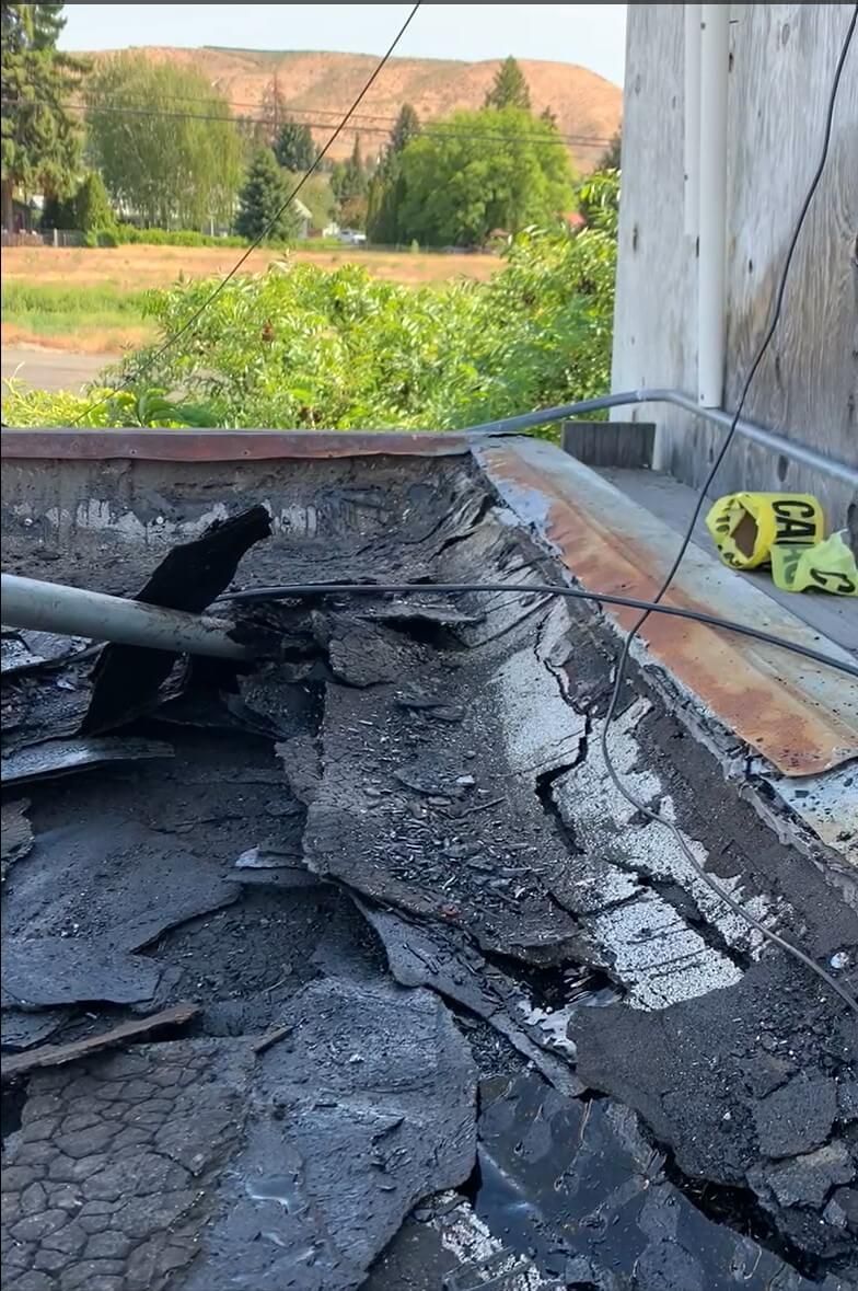 Tear-off process revealing the roof decking at Naches Fruit Stand in Naches, WA.