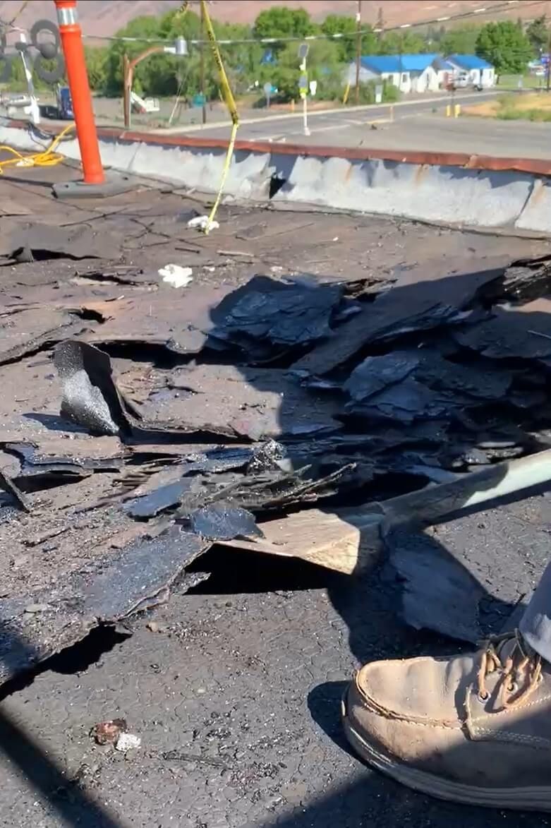 Close-up of roof tear-off process at Naches Fruit Stand in Naches, WA, showing removed layers of old roofing.