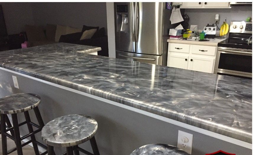 Modern epoxy countertops with metal bar stools in a contemporary kitchen