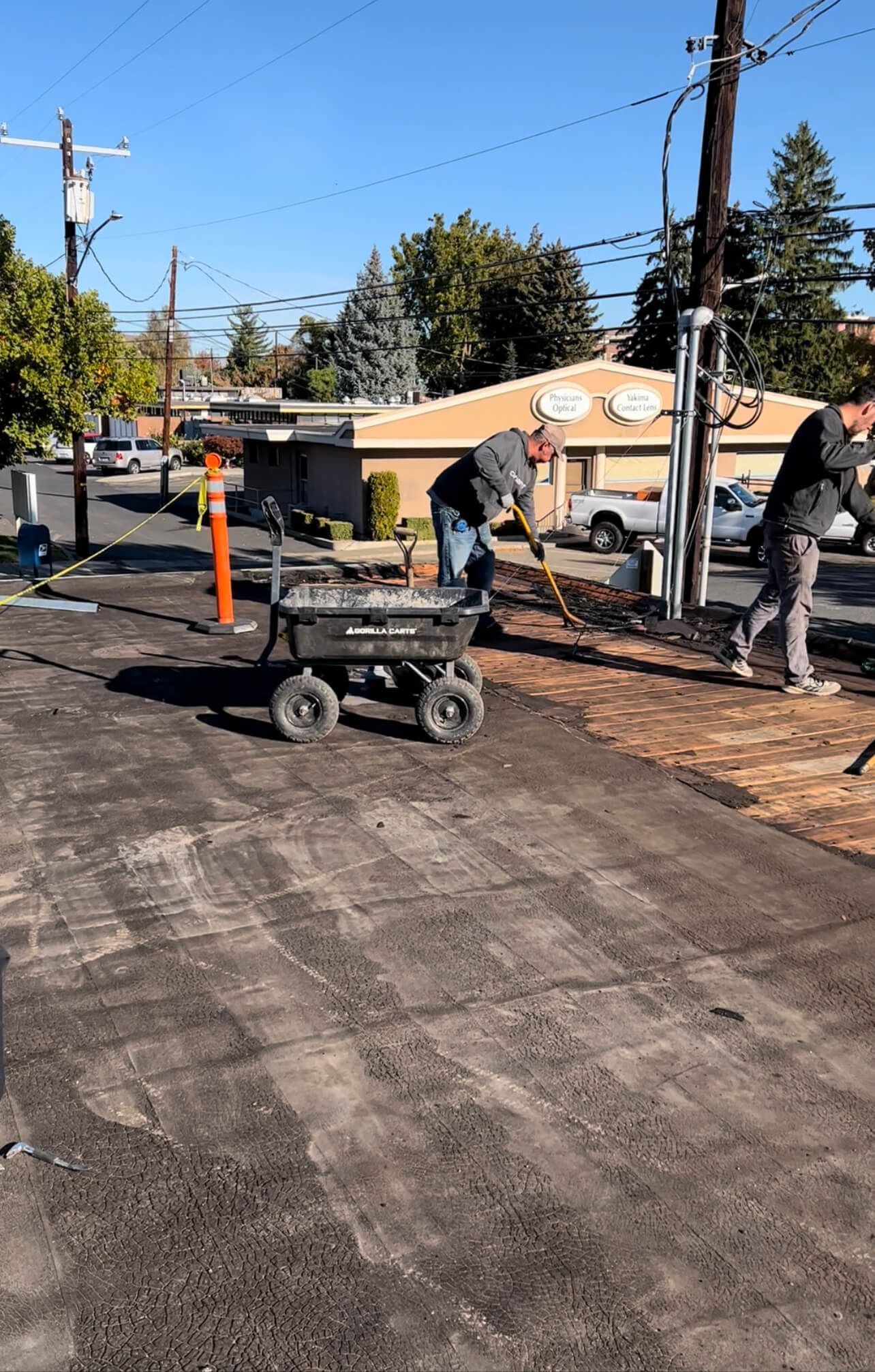 Roofing crew removing the built-up roof system during the Labcorp reroof project in Yakima.